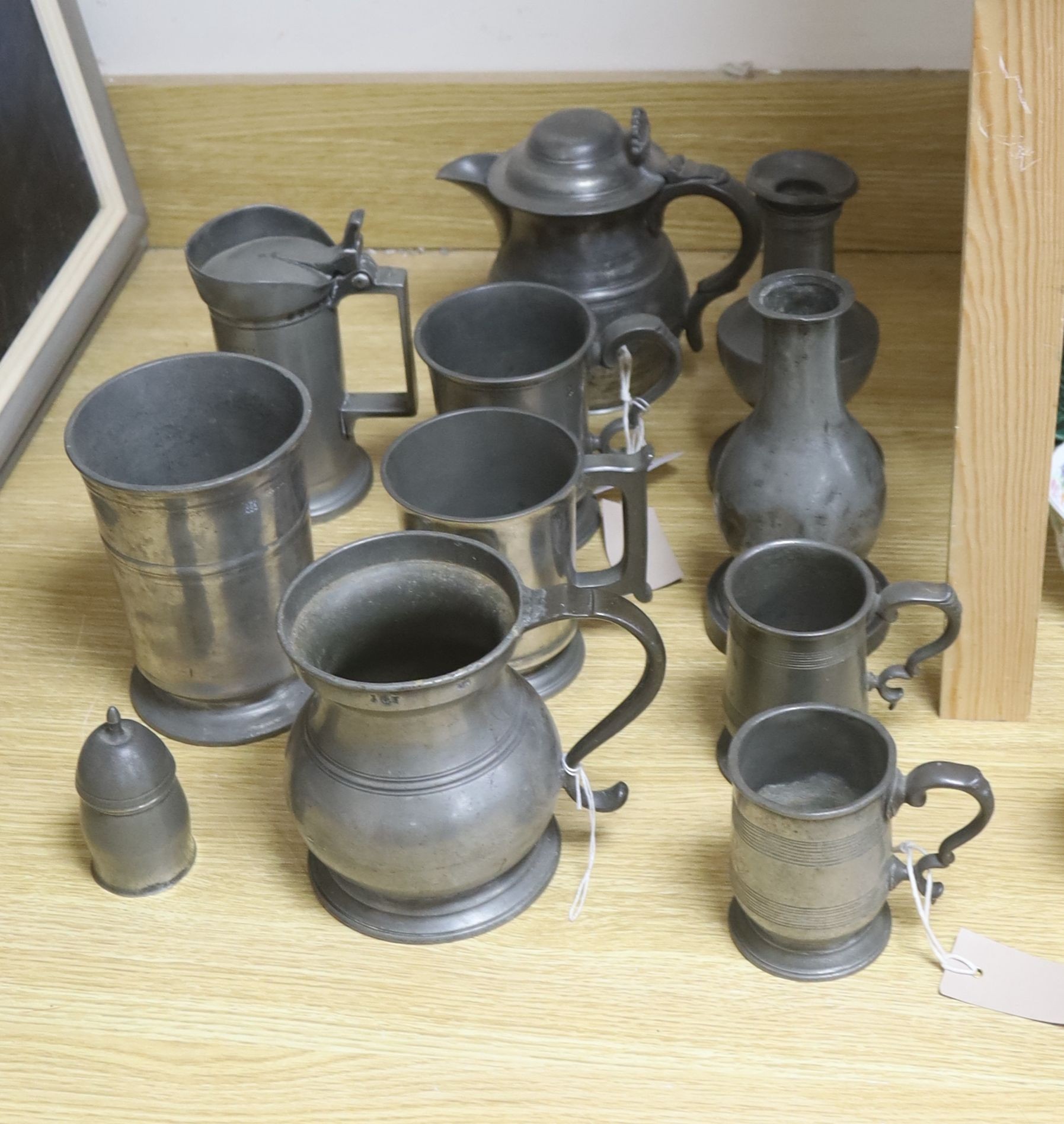 A group of 19th century French and British pewter mugs, measures and other vessels etc.